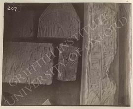 [Left upper left] Lower part of stela of Ptah-Kha with his wife and family before Anubis, Dyn. XI...