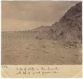 [354] Side of cliff in the desert, with top of great pyramid.