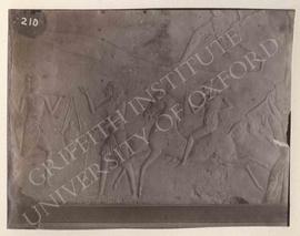 Block showing a military camp with chariots, horsemen, men carrying log, etc., from Saqqara, Tomb...